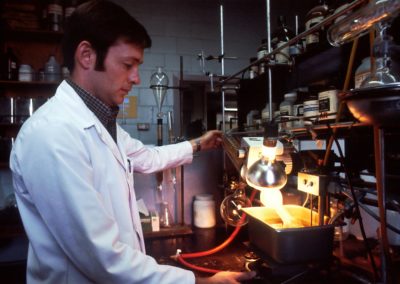 man in white chef suit holding stainless steel kettle